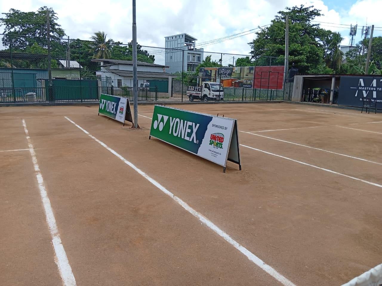 The same clay courts after the sponsorship, with Yonex × United Sports A-frame boards courtside