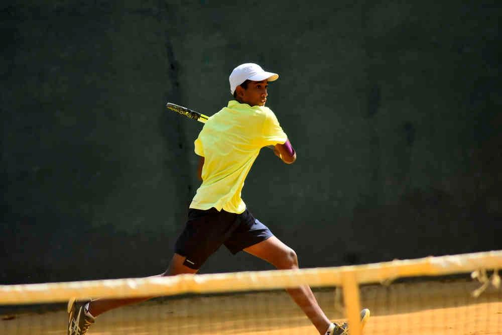 A Masters Tennis Academy junior lining up a backhand at the net